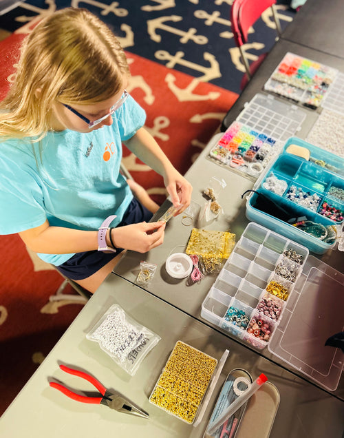 Ava working at her craft table making Ava’s Creations 